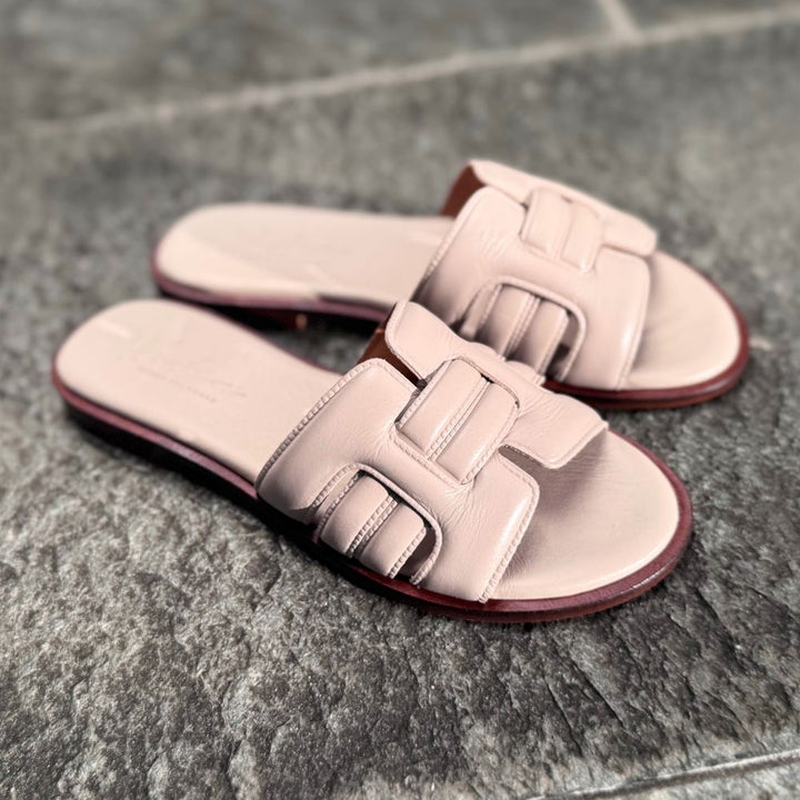 NoAna Greek Sandals City Chic ivory, flache Sandalen aus Glattleder, elegant und zeitlos auf Steinboden im Outdoor-Setting